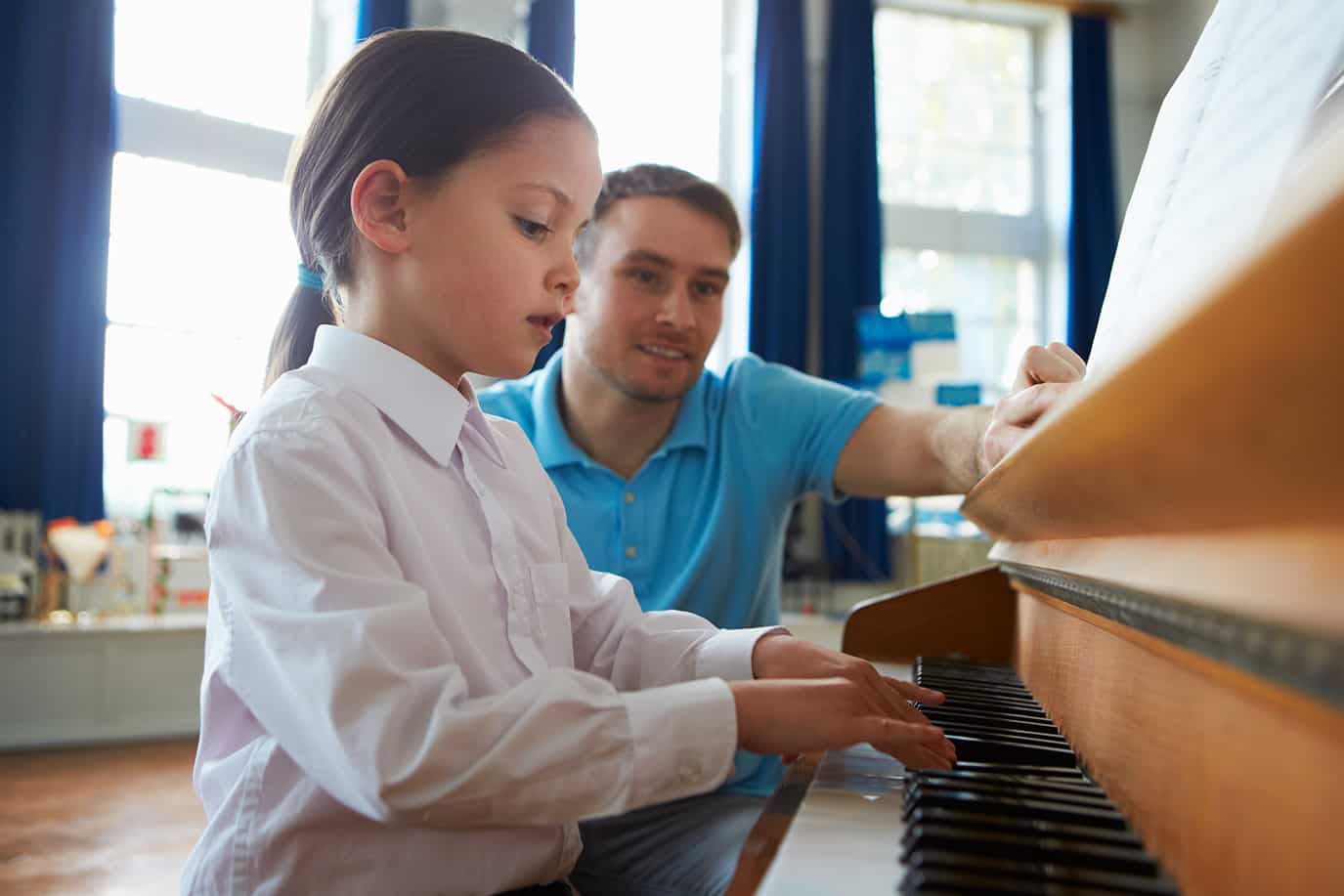 Young girl in piano lesson