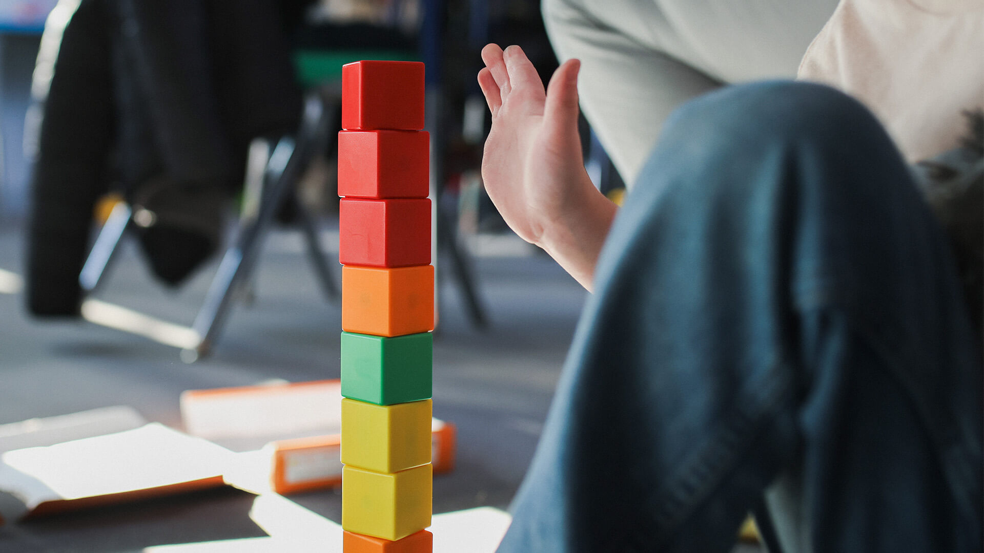 Child plays and stacks colorful blocks