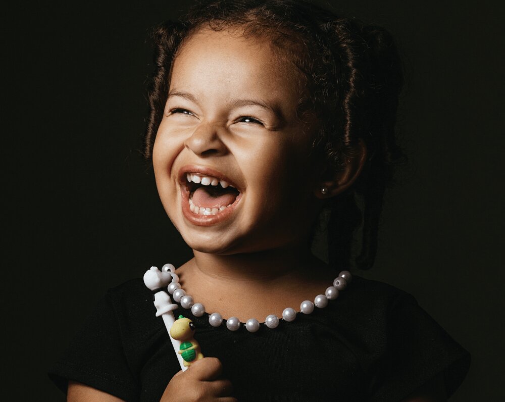 laughing girl holding toys
